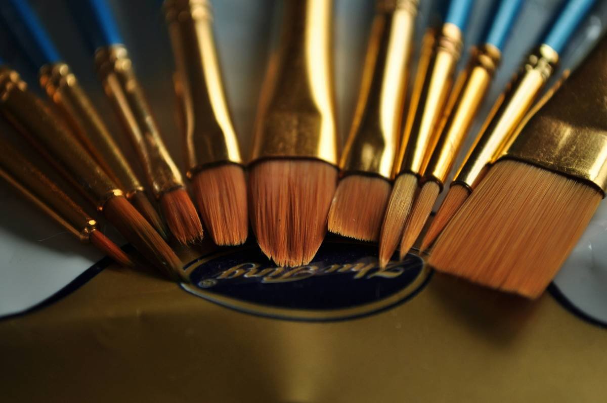 Close-up shot of a synthetic brow brush applying powder to eyebrows