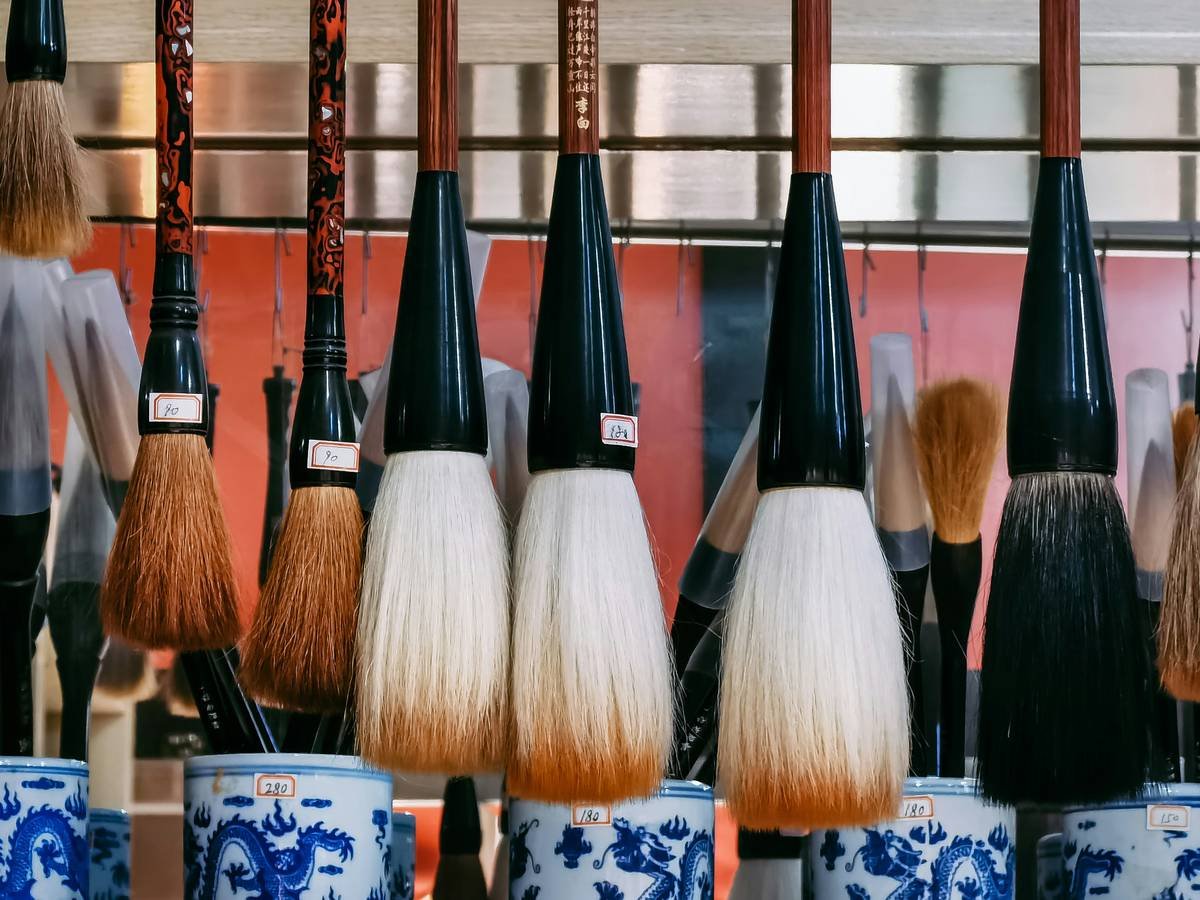 Close-up shot of a high-quality cosmetic defining brush with fine bristles on a white background.